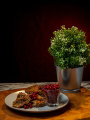 Traditional Finnish cuisines; closeup of a liver caseroll dish on a plate with fresh lingonberries...