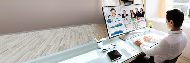 Businessman videoconferencing on computer