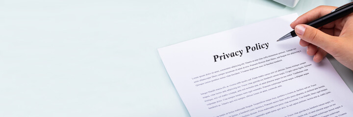 Woman Holding Pen Over Privacy Policy Form - obrazy, fototapety, plakaty