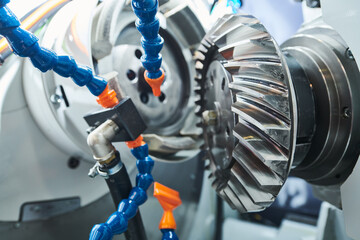 Spiral gear milling machine work. CNC grinding machine in metalwork industry