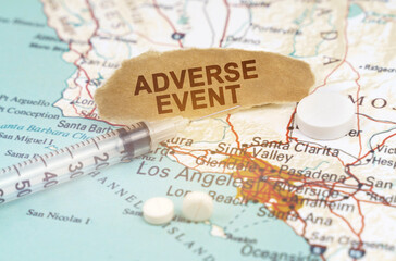 On a map of California lies a syringe, pills and paper with the inscription - adverse event