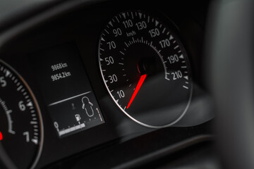 Close up view of a speedometer in a car. Kilometer counter. Car speedometer and dashboard.