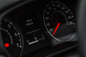 Close up view of a speedometer in a car. Kilometer counter. Car speedometer and dashboard.