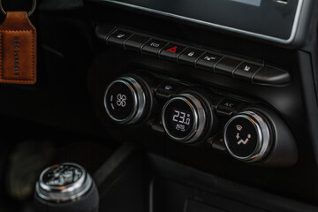 Obraz na płótnie Canvas Color car air conditioning buttons close up view inside a car. Car temperature conditioner dashboard panel.