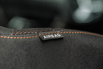 Close up view of airbag label on the side of a car seat. Airbag safety system symbol on the car...