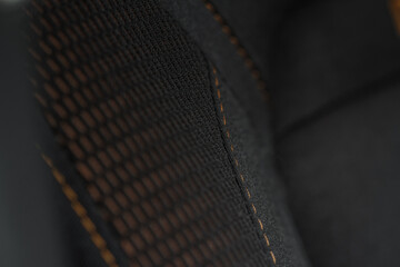 High angle view of modern car fabric seats. Close-up car seat texture and interior details. Detailed image of a car pleats stitch work.