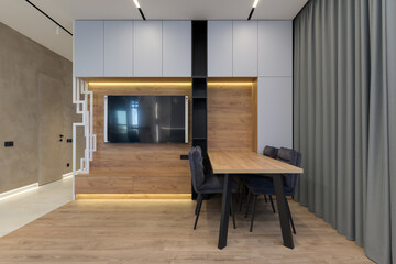 Modern luxury stylish apartment interior in pastel colors. a very bright room with huge windows filled with daylight. blue walls, wooden parquet floors