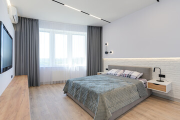 Modern luxury stylish apartment interior in pastel colors. a very bright room with huge windows filled with daylight. blue walls, wooden parquet floors