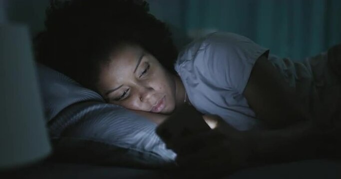 Sleepless woman connecting with her phone at night