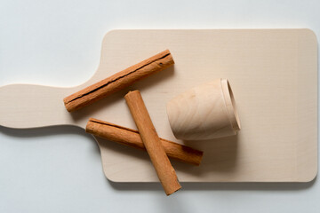 cinnamon sticks and wooden cup
