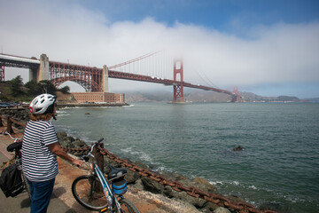 A Cyclist Enjoying as View of the Golden Gate Bridge in San Francisco California while taking a...