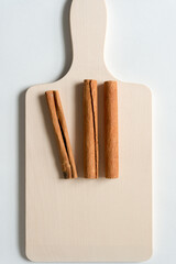 cinnamon sticks on a wooden paddle