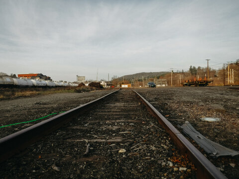 Railroad tracks in open gravel area 