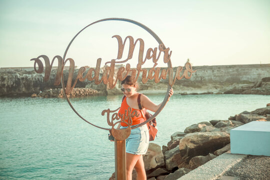 girl in Tarifa between the Mediterranean Sea and the Atlantic Ocean walking
