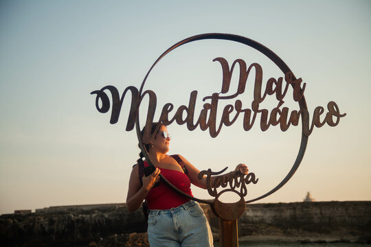 girl in Tarifa between the Mediterranean Sea and the Atlantic Ocean walking
