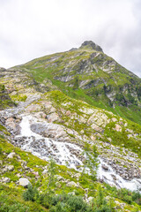Wild alpine waterfall on Schlatenbach mountain stream. Gschloesstal Valley, Hohe Tauern National Park, East Tyrol, Austrian Alps