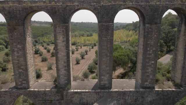 Drone footage of amazing Aqueduct, flying through and backwards, very close to the arc, ending in a beautiful aerial view. Used in the past to take water to a convent.