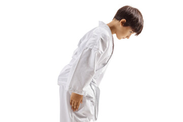 Karate kid in white kimono bowing