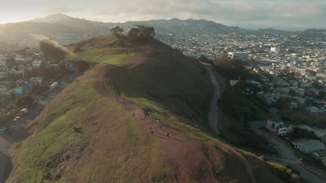 Aerial flying over Bernal Heights Park with a view to the San Francisco City skyline. California, USA