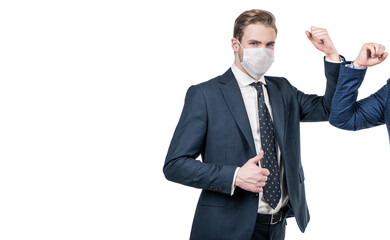 Businessman in mask elbow bump with colleague showing thumbs up, alternative greeting