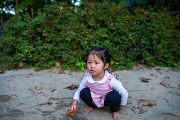 little child playing with sands 
