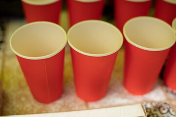 Empty glasses. Red drink cups. Distribution of coffee. Table with drinks.