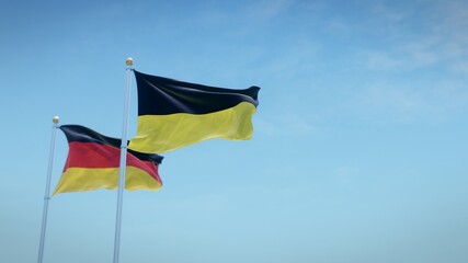 Waving flags of Germany and the German state of Baden-Württemberg against blue sky backdrop. 3d rendering