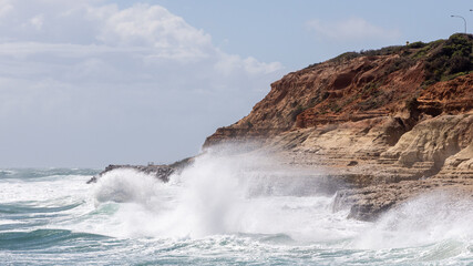 A big swell hitting the limestone cliff faces at port noarlunga south australia on october 4th 2021