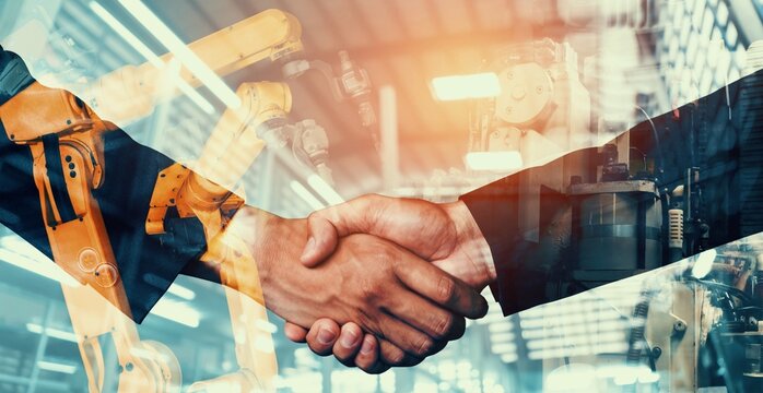 Mechanized industry robot arm and business handshake double exposure . Concept of successful agreement of artificial intelligence for industrial revolution and automation process in future factory .