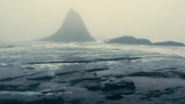 Aerial: Stormy coastline and shark fin rock. Martins beach, San Francisco, California, USA