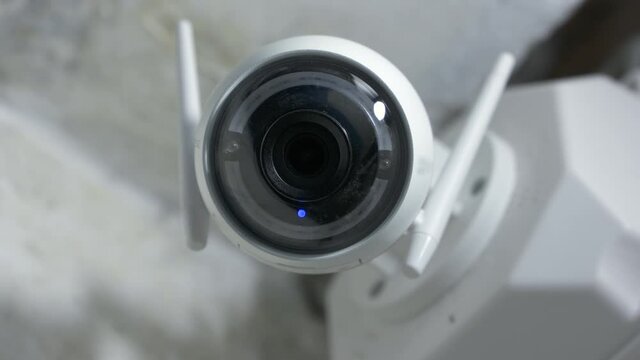 Modern home security surveillance Wi-Fi camera on a wall. High quality 4k footage