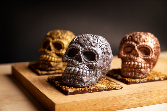 edible ornamented mexican skull made of chocolate gourmet, traditional gift for "dia de muertos" day of the death in Mexico culture named "calaverita de azucar" or "calaverita de chocolate".