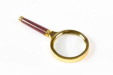 brass magnifying glass isolated on white background