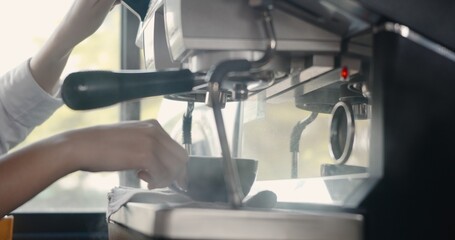 Hand of barista cleaning steam and smoke warm the milk from coffee machine, Vaporizer by streaming pressure, Boiling water into a cup out of a coffee machinery maker