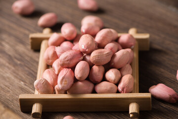 raw peanuts seed on wooden background