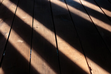 sunlight and shadows on wooden floor