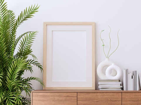 Blank picture frame on wooden cabinet with white wall background 3d render decorate palm tree and minimal style vase