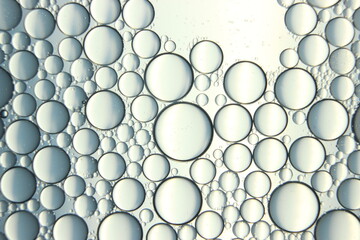 abstract macro background of oil circles floating over water surface .