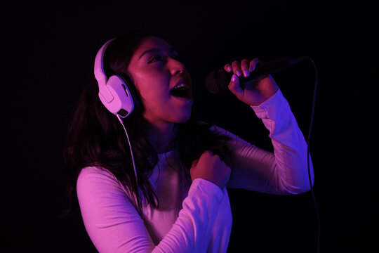 Latin woman singing with colored lights