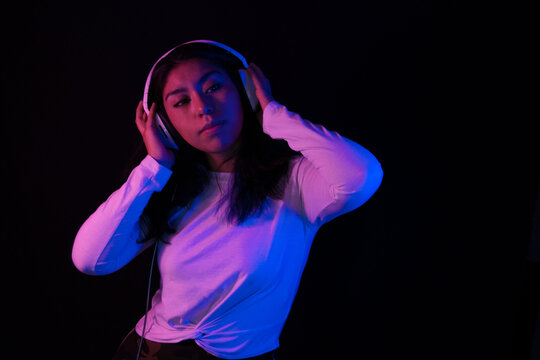 Girl listening to relaxing music with headphones
