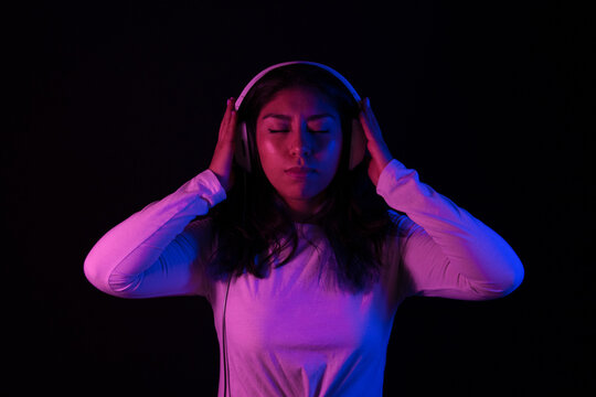 Girl listening to songs with headphones from s and phone