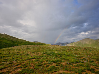 Developing Rainbow on an alpine meadow in the Rocky Mountains Continental divide