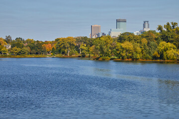 City of Minneapolis skyline on a beautiful day in fall with a lake in the foreground