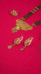 Mangalsutra or Golden Necklace to wear by a married hindu women, arranged with beautiful backgrond. Indian Traditional Jewellery.