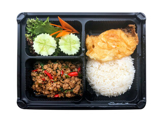 One of the most famous Thai food , Salted pork with chili and rice and fried egg in in the plastic box isolated on white background.