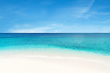Beautiful beach with white sand, turquoise ocean water and blue sky with sofe clouds in sunny day. Natural background for summer vacation