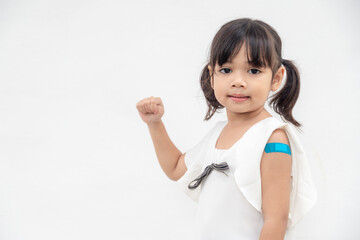 Asian little girl showing his arm after got vaccinated or inoculation, child immunization, covid...