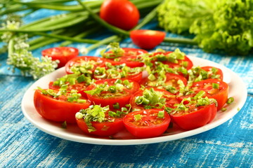 Healthy vegetarian diet meal- homemade organic tomato salad with fresh herbs and greens.