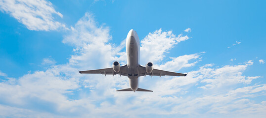 White passenger airplane over the clouds  - Travel by air transport