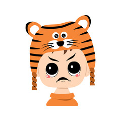 Avatar of boy with angry emotions, grumpy face, furious eyes in tiger hat. Cute kid with furious expression in carnival costume for New Year, Christmas and holiday. Head of adorable child